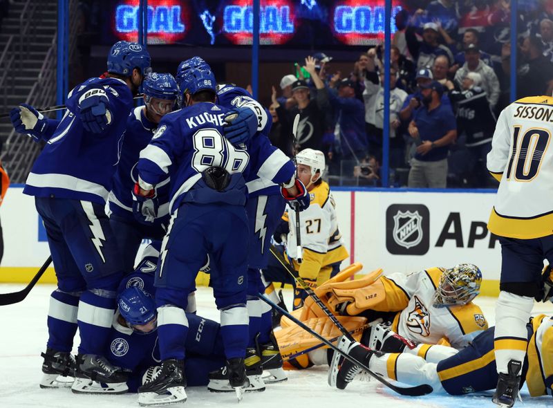 Oct 10, 2023; Tampa, Florida, USA; Tampa Bay Lightning left wing Nicholas Paul (20) is congratulated after he scored a goal on Nashville Predators goaltender Juuse Saros (74)  during the third period at Amalie Arena. Mandatory Credit: Kim Klement Neitzel-USA TODAY Sports