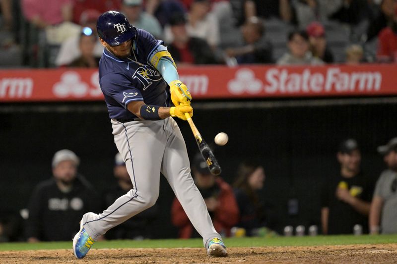 Apr 9, 2024; Anaheim, California, USA;  Tampa Bay Rays third base Isaac Paredes (17) hits a solo home run in the seventh inning against the Los Angeles Angels at Angel Stadium. Mandatory Credit: Jayne Kamin-Oncea-USA TODAY Sports