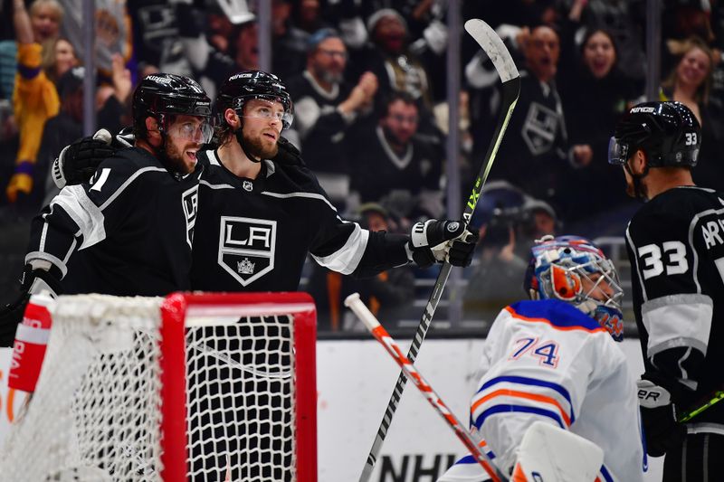 Apr 29, 2023; Los Angeles, California, USA; Los Angeles Kings right wing Adrian Kempe (9) celebrates his power play goal scored against the Edmonton Oilers with center Anze Kopitar (11) during the second period in game six of the first round of the 2023 Stanley Cup Playoffs at Crypto.com Arena. Mandatory Credit: Gary A. Vasquez-USA TODAY Sports