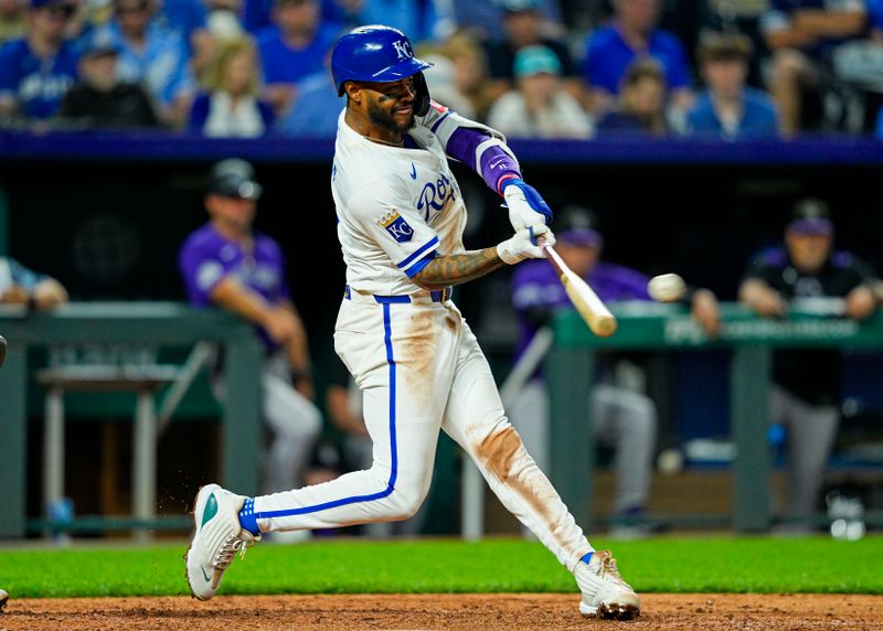 Apr 22, 2025; Kansas City, Missouri, USA; Kansas City Royals third baseman Maikel Garcia (11) hits a double during the ninth inning against the Colorado Rockies at Kauffman Stadium. Mandatory Credit: Jay Biggerstaff-Imagn Images