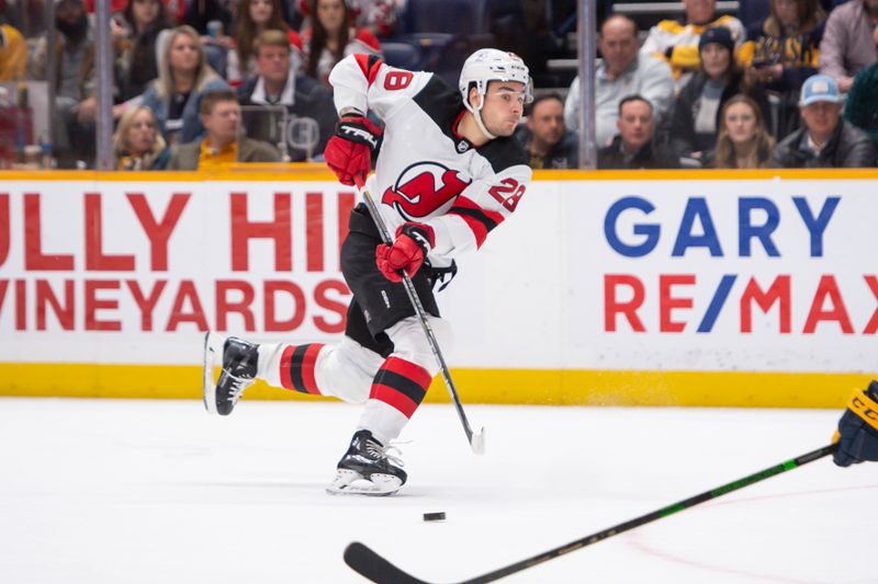 Feb 13, 2024; Nashville, Tennessee, USA;  New Jersey Devils right wing Timo Meier (28) passes the puck against the Nashville Predators during the second period at Bridgestone Arena. Mandatory Credit: Steve Roberts-USA TODAY Sports