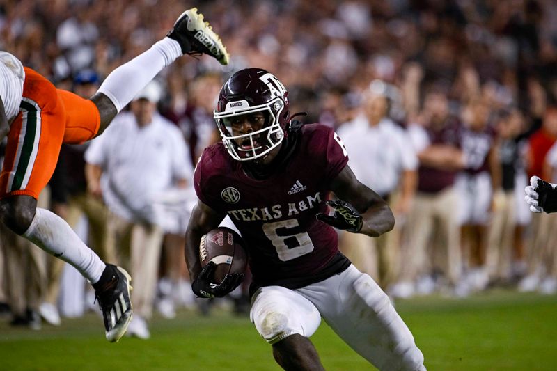 Sep 17, 2022; College Station, Texas, USA; Texas A&M Aggies running back Devon Achane (6) scores a touchdown against the Miami Hurricanes during the second half at Kyle Field. Mandatory Credit: Jerome Miron-USA TODAY Sports