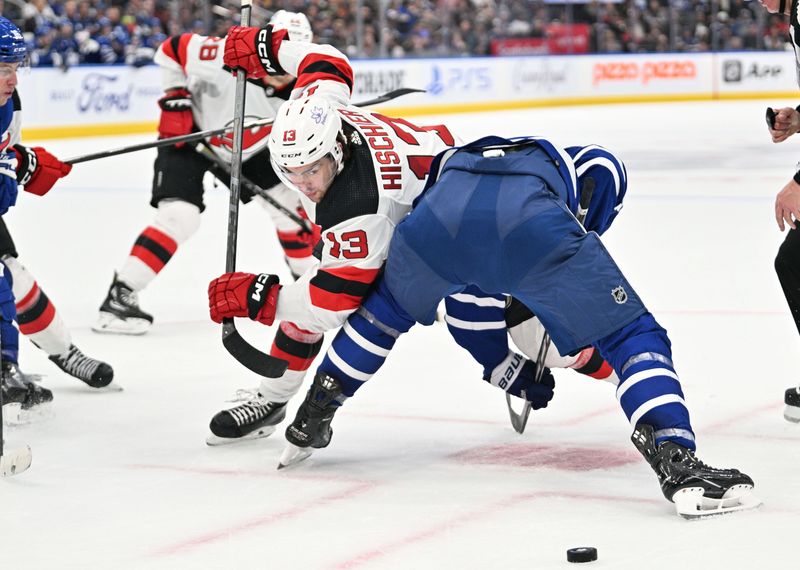 Apr 11, 2024; Toronto, Ontario, CAN; New Jersey Devils forward Nico Hischier (13) looks for the puck after losing a face off against the Toronto Maple Leafs in the second period at Scotiabank Arena. Mandatory Credit: Dan Hamilton-USA TODAY Sports