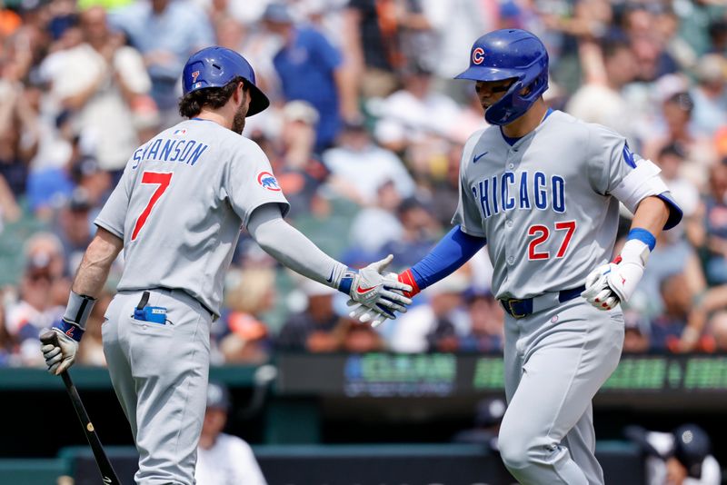 Jun 7, 2025; Detroit, Michigan, USA;  Chicago Cubs outfielder Seiya Suzuki (27) receives congratulations from shortstop Dansby Swanson (7) after he hits a home run in the eighth inning against the Detroit Tigers at Comerica Park. Mandatory Credit: Rick Osentoski-Imagn Images