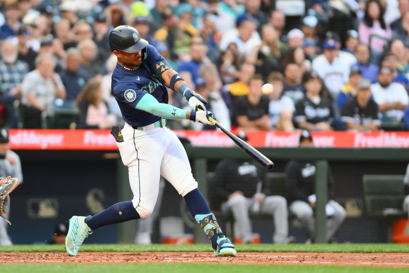 Jun 10, 2024; Seattle, Washington, USA; Seattle Mariners center fielder Julio Rodriguez (44) hits a single against the Chicago White Sox during the fourth inning at T-Mobile Park. Mandatory Credit: Steven Bisig-USA TODAY Sports