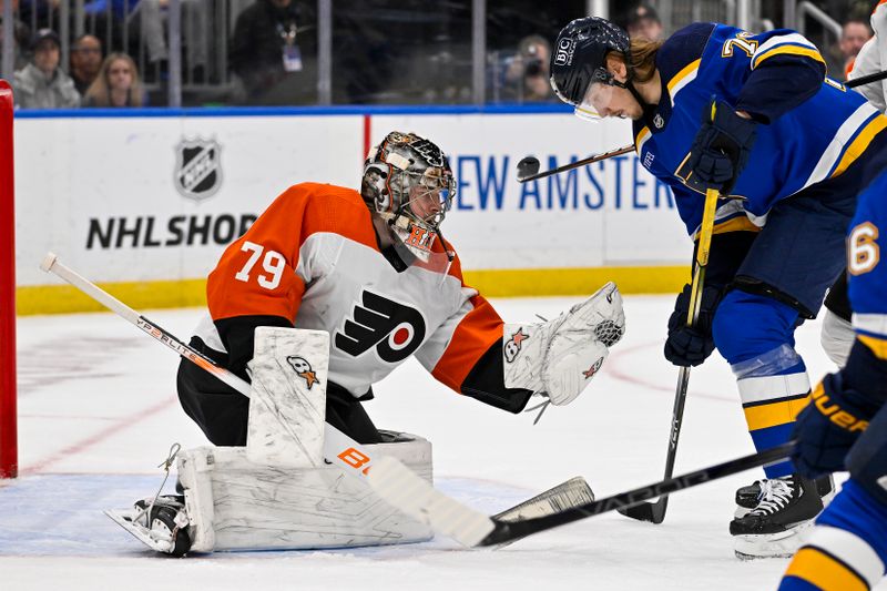 Jan 15, 2024; St. Louis, Missouri, USA;  Philadelphia Flyers goaltender Carter Hart (79) defends the net against St. Louis Blues center Oskar Sundqvist (70) during the second period at Enterprise Center. Mandatory Credit: Jeff Curry-USA TODAY Sports