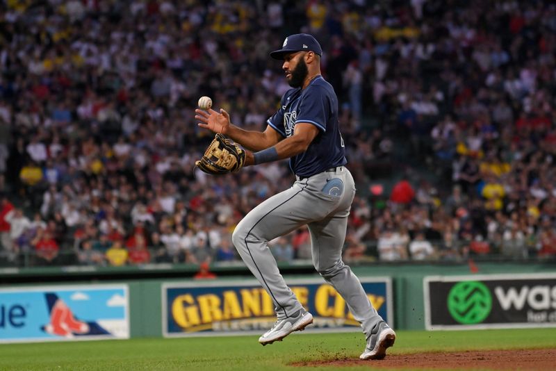 May 14, 2024; Boston, Massachusetts, USA; Tampa Bay Rays third baseman Amed Rosario (10) mishandles the ball during the fourth inning against the Boston Red Sox at Fenway Park. Mandatory Credit: Eric Canha-USA TODAY Sports