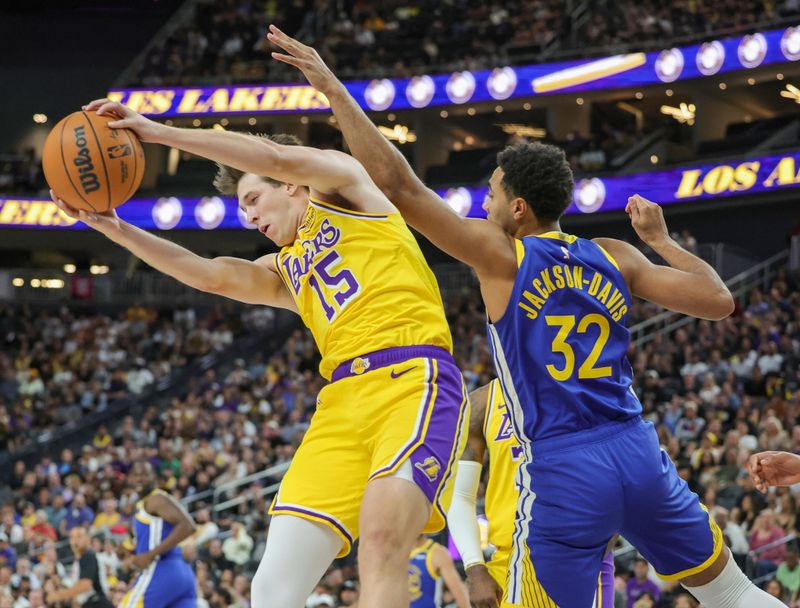 LAS VEGAS, NEVADA - OCTOBER 15: Austin Reaves #15 of the Los Angeles Lakers grabs a rebound against Trayce Jackson-Davis #32 of the Golden State Warriors in the first quarter of their preseason game at T-Mobile Arena at T-Mobile Arena on October 15, 2024 in Las Vegas, Nevada. NOTE TO USER: User expressly acknowledges and agrees that, by downloading and or using this photograph, User is consenting to the terms and conditions of the Getty Images License Agreement. (Photo by Ethan Miller/Getty Images)