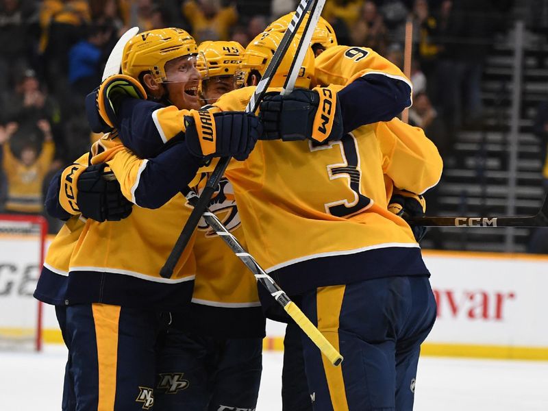 Jan 13, 2024; Nashville, Tennessee, USA; Nashville Predators defenseman Alexandre Carrier (45) celebrates with teammates after scoring the game-winning goal during the third period against the New York Islanders at Bridgestone Arena. Mandatory Credit: Christopher Hanewinckel-USA TODAY Sports