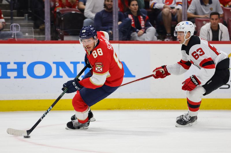 Nov 12, 2024; Sunrise, Florida, USA; Florida Panthers defenseman Nate Schmidt (88) moves the puck past New Jersey Devils left wing Jesper Bratt (63) during the first period at Amerant Bank Arena. Mandatory Credit: Sam Navarro-Imagn Images