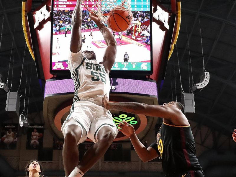 Dec 4, 2024; Minneapolis, Minnesota, USA; Michigan State Spartans forward Coen Carr (55) dunks against the Minnesota Golden Gophers during the second half at Williams Arena. Mandatory Credit: Matt Krohn-Imagn Images