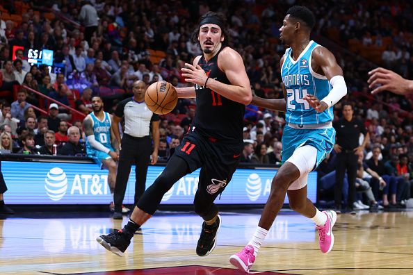 MIAMI, FLORIDA - DECEMBER 13: Jaime Jaquez Jr. #11 of the Miami Heat drives against Brandon Miller #24 of the Charlotte Hornets during the second quarter at Kaseya Center on December 13, 2023 in Miami, Florida. NOTE TO USER: User expressly acknowledges and agrees that, by downloading and or using this photograph, User is consenting to the terms and conditions of the Getty Images License Agreement. (Photo by Megan Briggs/Getty Images)