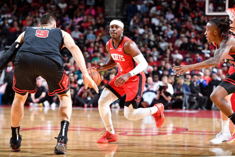 HOUSTON, TX - MARCH 21:   Aaron Holiday #0 of the Houston Rockets handles the ball during the game against the Chicago Bulls on March 21, 2024 at the Toyota Center in Houston, Texas. NOTE TO USER: User expressly acknowledges and agrees that, by downloading and or using this photograph, User is consenting to the terms and conditions of the Getty Images License Agreement. Mandatory Copyright Notice: Copyright 2024 NBAE (Photo by Logan Riely/NBAE via Getty Images)