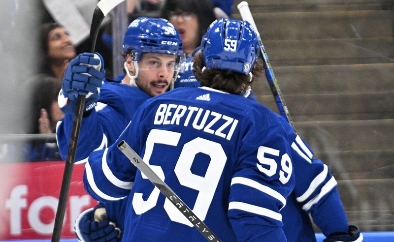 Apr 11, 2024; Toronto, Ontario, CAN; Toronto Maple Leafs forward Auston Matthews (34) celebrates with forward Tyler Bertuzzi (59) after scoring a goal against the New Jersey Devils in the first period at Scotiabank Arena. Mandatory Credit: Dan Hamilton-USA TODAY Sports