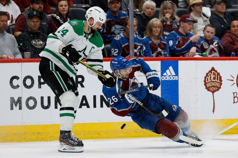 May 13, 2024; Denver, Colorado, USA; Colorado Avalanche defenseman Sean Walker (26) falls to the ice against Dallas Stars left wing Jamie Benn (14) in the second period in game four of the second round of the 2024 Stanley Cup Playoffs at Ball Arena. Mandatory Credit: Isaiah J. Downing-USA TODAY Sports