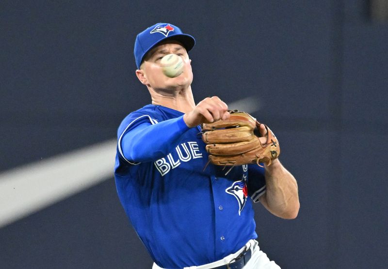 Aug 26, 2023; Toronto, Ontario, CAN;  Toronto Blue Jays third baseman Matt Chapman (26) throws to retire Cleveland Guardians left fielder Oscar Gonzalez (not shown) in the fourth inning at Rogers Centre. Mandatory Credit: Dan Hamilton-USA TODAY Sports