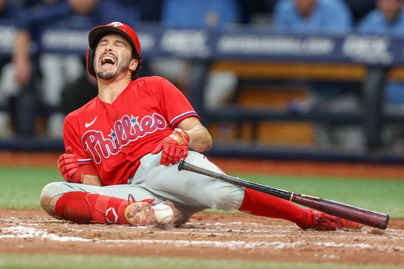 Jul 6, 2023; St. Petersburg, Florida, USA;  Philadelphia Phillies catcher Garrett Stubbs (21) is hit by a pitch against the Tampa Bay Rays in the eleventh inning at Tropicana Field. Mandatory Credit: Nathan Ray Seebeck-USA TODAY Sports