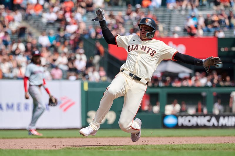 Apr 10, 2024; San Francisco, California, USA; San Francisco Giants shortstop Nick Ahmed (16) begins to slide into third base against the Washington Nationals during the sixth inning at Oracle Park. Mandatory Credit: Robert Edwards-USA TODAY Sports