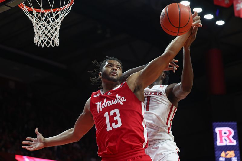 Feb 14, 2023; Piscataway, New Jersey, USA; Nebraska Cornhuskers forward Derrick Walker (13) rebounds against Rutgers Scarlet Knights center Clifford Omoruyi (11) during the first half at Jersey Mike's Arena. Mandatory Credit: Vincent Carchietta-USA TODAY Sports