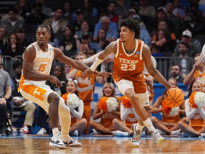 March 23, 2024, Charlotte, NC, USA; Texas Longhorns forward Dillon Mitchell (23) dribbles against Tennessee Volunteers guard Jahmai Mashack (15) in the second round of the 2024 NCAA Tournament at the Spectrum Center. Mandatory Credit: Jim Dedmon-USA TODAY Sports