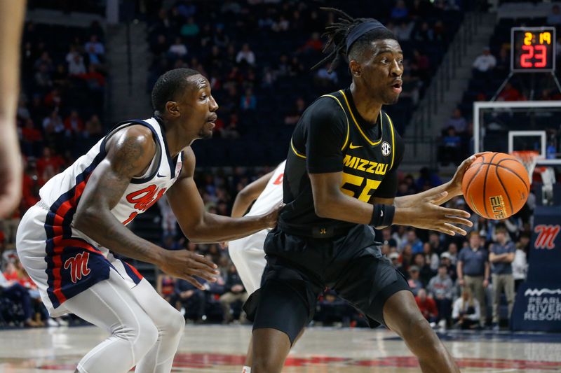 Jan 24, 2023; Oxford, Mississippi, USA; Missouri Tigers guard Sean East II (55) passes the ball as Mississippi Rebels guard Tye Fagan (14) defends during the first half at The Sandy and John Black Pavilion at Ole Miss. Mandatory Credit: Petre Thomas-USA TODAY Sports