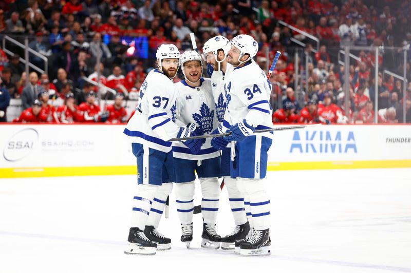 Mar 20, 2024; Washington, District of Columbia, USA; Toronto Maple Leafs center Max Domi (11) celebrates with teammates after scoring a goal against the Washington Capitals during the second period at Capital One Arena. Mandatory Credit: Amber Searls-USA TODAY Sports