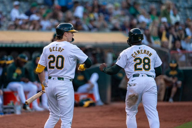 Aug 5, 2024; Oakland, California, USA;  Oakland Athletics right fielder Daz Cameron (28) and Oakland Athletics second baseman Zack Gelof (20) celebrate during the first inning against the Chicago White Sox at Oakland-Alameda County Coliseum. Mandatory Credit: Neville E. Guard-USA TODAY Sports