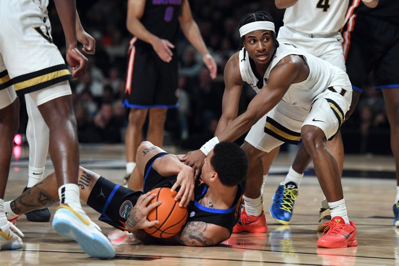 Mar 9, 2024; Nashville, Tennessee, USA; Vanderbilt Commodores guard Ezra Manjon (5) ties up the ball for a jump ball against Florida Gators guard Riley Kugel (2) during the second half at Memorial Gymnasium. Mandatory Credit: Christopher Hanewinckel-USA TODAY Sports