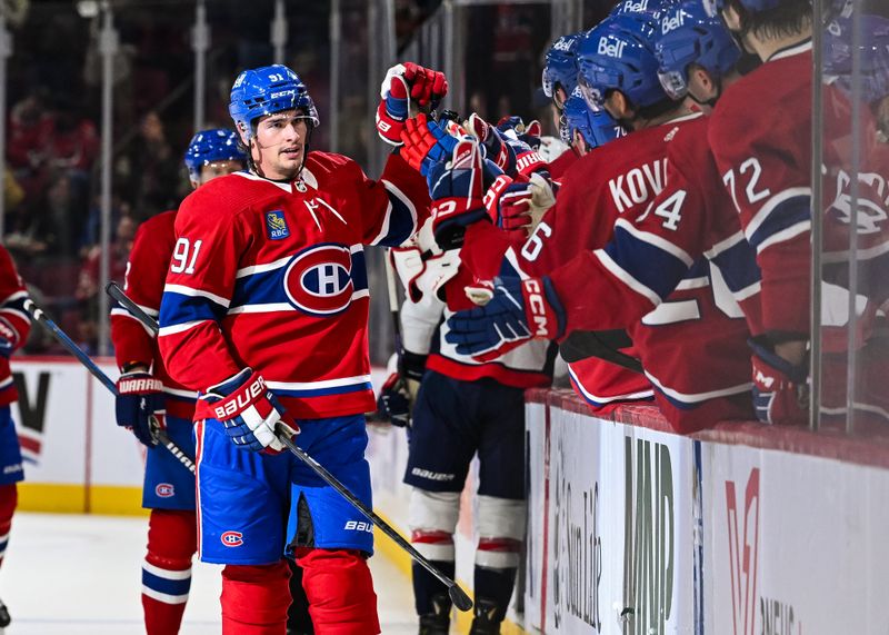 Oct 21, 2023; Montreal, Quebec, CAN; Montreal Canadiens center Sean Monahan (91) celebrates his goal against the Washington Capitals with his teammates at the bench during the first period at Bell Centre. Mandatory Credit: David Kirouac-USA TODAY Sports