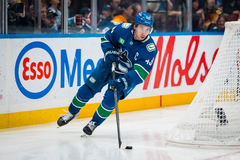 Oct 13, 2025; Vancouver, British Columbia, CAN; Vancouver Canucks defenseman Quinn Hughes (43) handles the puck against the St. Louis Blues in the third period at Rogers Arena. Mandatory Credit: Bob Frid-Imagn Images