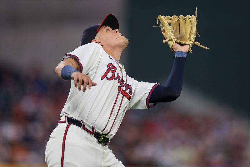 Sep 24, 2024; Atlanta, Georgia, USA; Atlanta Braves third baseman Gio Urshela (9) catches a pop fly against the New York Mets in the second inning at Truist Park. Mandatory Credit: Brett Davis-Imagn Images

