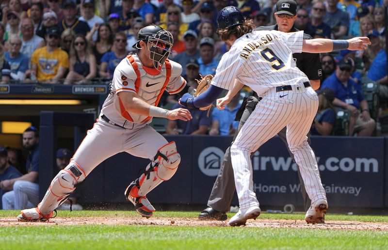 May 28, 2023; Milwaukee, Wisconsin, USA; Milwaukee Brewers third baseman Brian Anderson (9) is tagged out at home by San Francisco Giants catcher Blake Sabol (2) during the first inning at American Family Field. Mandatory Credit: Mark Hoffman/Milwaukee Journal Sentinel-USA TODAY Sports