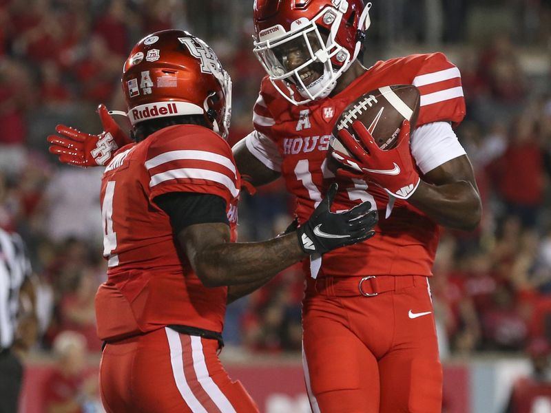 Sep 25, 2021; Houston, Texas, USA; Houston Cougars running back Ta'Zhawn Henry (4) celebrates with wide receiver Jeremy Singleton (13) after scoring a touchdown against the Navy Midshipmen during the third quarter at TDECU Stadium. Mandatory Credit: Troy Taormina-USA TODAY Sports