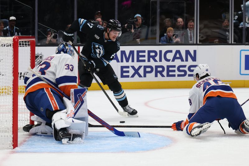 Nov 14, 2025; Salt Lake City, Utah, USA; Utah Mammoth center Barrett Hayton (27) looks to shoot against New York Islanders goaltender David Rittich (33) and defenseman Matthew Schaefer (48) during the third period at Delta Center. Mandatory Credit: Rob Gray-Imagn Images