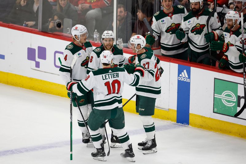 Feb 7, 2024; Chicago, Illinois, USA; Minnesota Wild center Jacob Lucchini (27) celebrates with teammates after scoring against the Chicago Blackhawks during the first period at United Center. Mandatory Credit: Kamil Krzaczynski-USA TODAY Sports