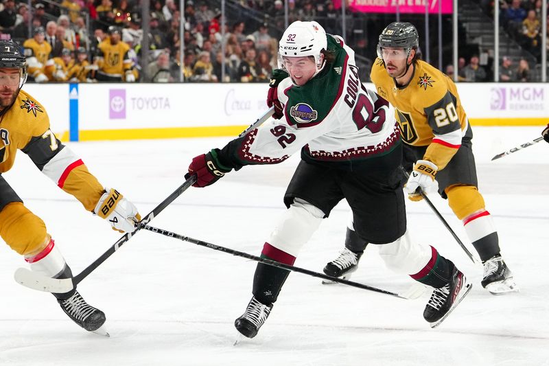 Nov 25, 2023; Las Vegas, Nevada, USA; Arizona Coyotes center Logan Cooley (92) shoots the puck against the Vegas Golden Knights during the second period at T-Mobile Arena. Mandatory Credit: Stephen R. Sylvanie-USA TODAY Sports