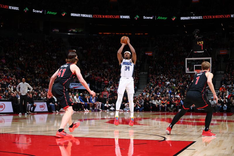 TORONTO, CANADA - JANUARY 3: Wendell Carter Jr. #34 of the Orlando Magic shoots a three point basket during the game against the Toronto Raptors on January 3, 2025 at the Scotiabank Arena in Toronto, Ontario, Canada.  NOTE TO USER: User expressly acknowledges and agrees that, by downloading and or using this Photograph, user is consenting to the terms and conditions of the Getty Images License Agreement.  Mandatory Copyright Notice: Copyright 2025 NBAE (Photo by Vaughn Ridley/NBAE via Getty Images)