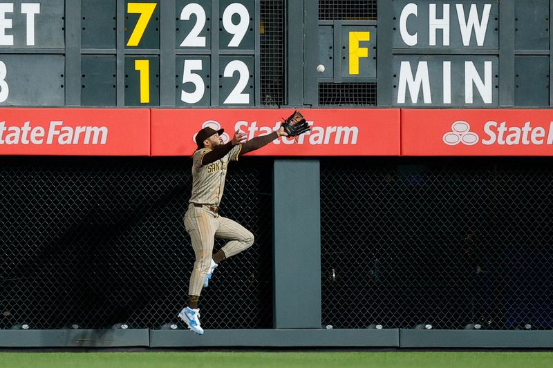 Apr 22, 2024; Denver, Colorado, USA; San Diego Padres right fielder Fernando Tatis Jr. (23) is unable to make a catch at the wall in the ninth inning against the Colorado Rockies at Coors Field. Mandatory Credit: Isaiah J. Downing-USA TODAY Sports