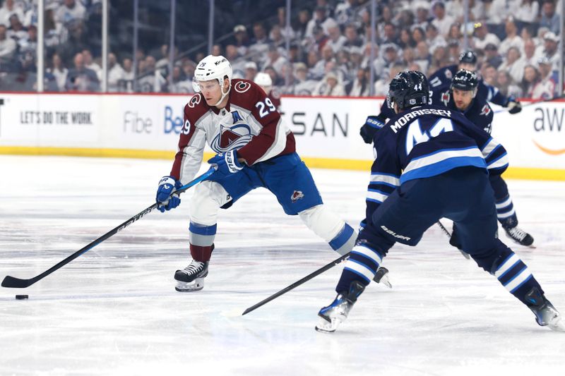 Apr 21, 2024; Winnipeg, Manitoba, CAN; Colorado Avalanche center Nathan MacKinnon (29) skates up the ice to Winnipeg Jets defenseman Josh Morrissey (44) in the first period in game one of the first round of the 2024 Stanley Cup Playoffs at Canada Life Centre. Mandatory Credit: James Carey Lauder-USA TODAY Sports