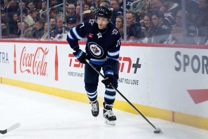 Mar 15, 2024; Winnipeg, Manitoba, CAN; Winnipeg Jets forward Nikolaj Ehlers (27) looks to make a pass in the Anaheim Ducks zone during the second period at Canada Life Centre. Mandatory Credit: Terrence Lee-USA TODAY Sports