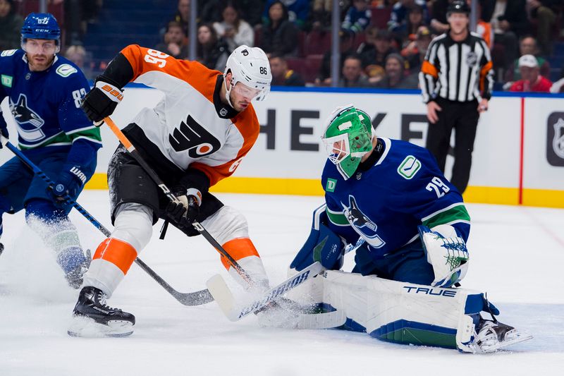 Dec 28, 2023; Vancouver, British Columbia, CAN; Vancouver Canucks goalie Casey DeSmith (29) makes a save on Philadelphia Flyers forward Joel Farabee (86) in the first period at Rogers Arena. Mandatory Credit: Bob Frid-USA TODAY Sports