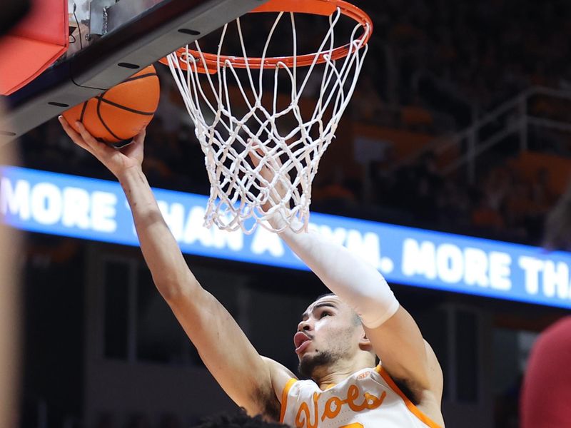 Feb 28, 2023; Knoxville, Tennessee, USA; Tennessee Volunteers forward Olivier Nkamhoua (13) goes to the basket against the Arkansas Razorbacks during the first half at Thompson-Boling Arena. Mandatory Credit: Randy Sartin-USA TODAY Sports