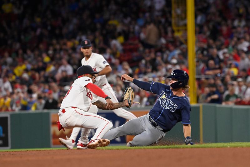 May 14, 2024; Boston, Massachusetts, USA; Tampa Bay Rays center fielder Jonny DeLuca (21) gets tagged out by Boston Red Sox shortstop Ceddanne Rafaela (43) trying to steal second base during the fifth inning at Fenway Park. Mandatory Credit: Eric Canha-USA TODAY Sports