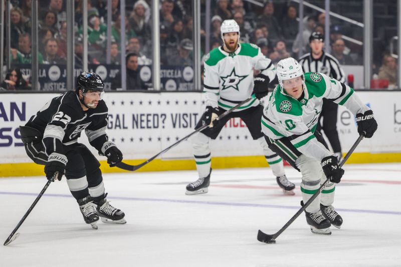 Mar 9, 2024; Los Angeles, California, USA; Dallas Stars center Ty Dellandrea (10) moves the puck as Los Angeles Kings center Trevor Lewis (22) pursues during the third period at Crypto.com Arena. Mandatory Credit: Yannick Peterhans-USA TODAY Sports