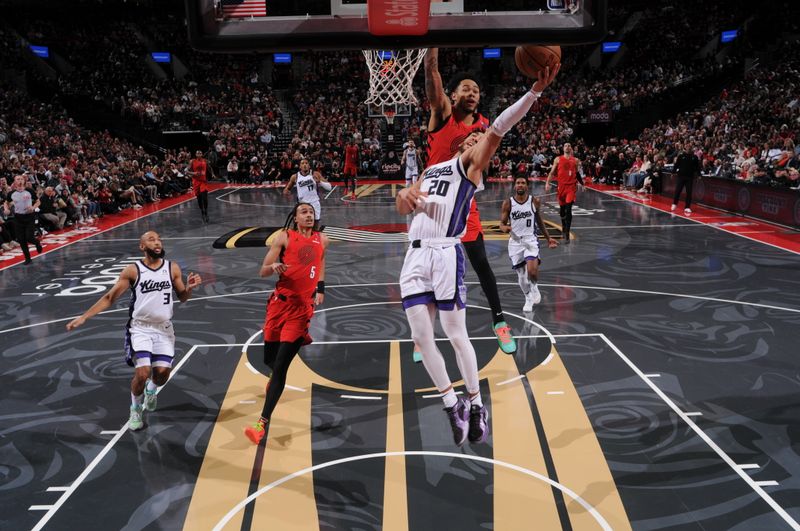 PORTLAND, OR - NOVEMBER 29: Colby Jones #20 of the Sacramento Kings drives to the basket during the game aPortland Trail Blazers during the Emirates NBA Cup on November 29, 2024 at the Moda Center Arena in Portland, Oregon. NOTE TO USER: User expressly acknowledges and agrees that, by downloading and or using this photograph, user is consenting to the terms and conditions of the Getty Images License Agreement. Mandatory Copyright Notice: Copyright 2024 NBAE (Photo by Cameron Browne/NBAE via Getty Images)