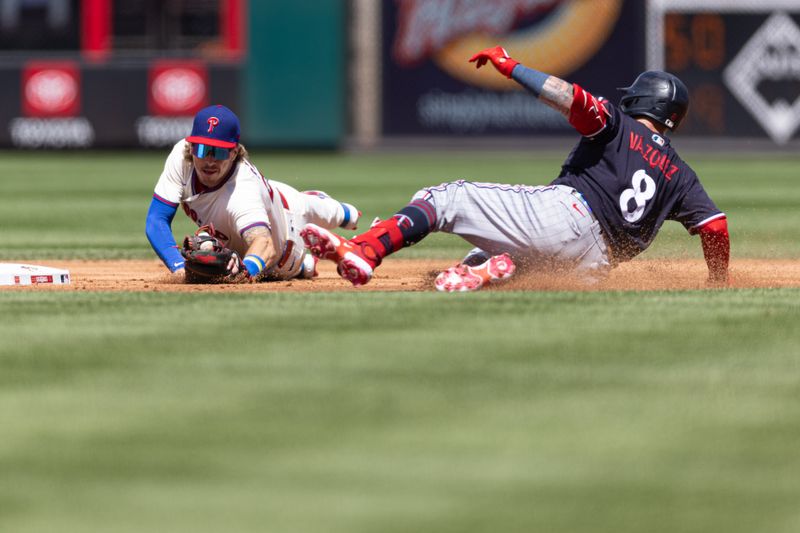 Aug 13, 2023; Philadelphia, Pennsylvania, USA; Minnesota Twins catcher Christian Vazquez (8) is tug out by Philadelphia Phillies second baseman Bryson Stott (5) after attempting to advance to second after hitting a single during the second inning at Citizens Bank Park. Mandatory Credit: Bill Streicher-USA TODAY Sports