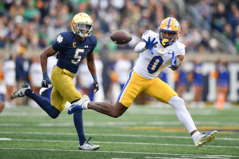 Oct 28, 2023; South Bend, Indiana, USA; Pittsburgh Panthers wide receiver Bub Means (0) catches a pass against Notre Dame Fighting Irish cornerback Cam Hart (5) in the second quarter at Notre Dame Stadium. Mandatory Credit: Matt Cashore-USA TODAY Sports