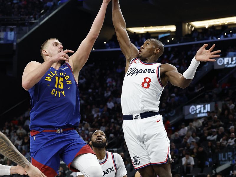 INGLEWOOD, CALIFORNIA - DECEMBER 01:  Kris Dunn #8 of the LA Clippers blocks the shot of Nikola Jokic #15 of the Denver Nuggets in the second half at Intuit Dome on December 01, 2024 in Inglewood, California.  NOTE TO USER: User expressly acknowledges and agrees that, by downloading and or using this photograph, User is consenting to the terms and conditions of the Getty Images License Agreement. (Photo by Ronald Martinez/Getty Images)