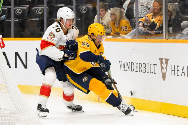 Feb 25, 2025; Nashville, Tennessee, USA;  Florida Panthers center Jesper Boqvist (70) checks Nashville Predators defenseman Roman Josi (59) into the boards during the second period at Bridgestone Arena. Mandatory Credit: Steve Roberts-Imagn Images