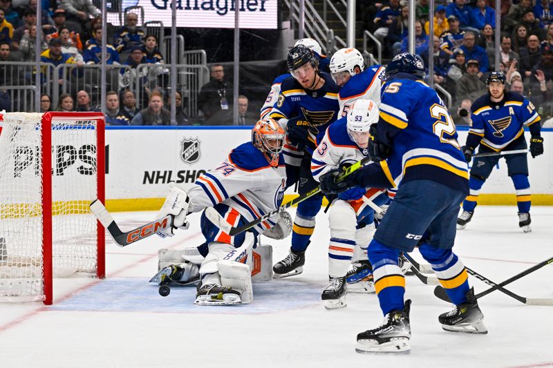 Feb 15, 2024; St. Louis, Missouri, USA;  St. Louis Blues center Jordan Kyrou (25) shoots and scores against Edmonton Oilers goaltender Stuart Skinner (74) during the second period at Enterprise Center. Mandatory Credit: Jeff Curry-USA TODAY Sports